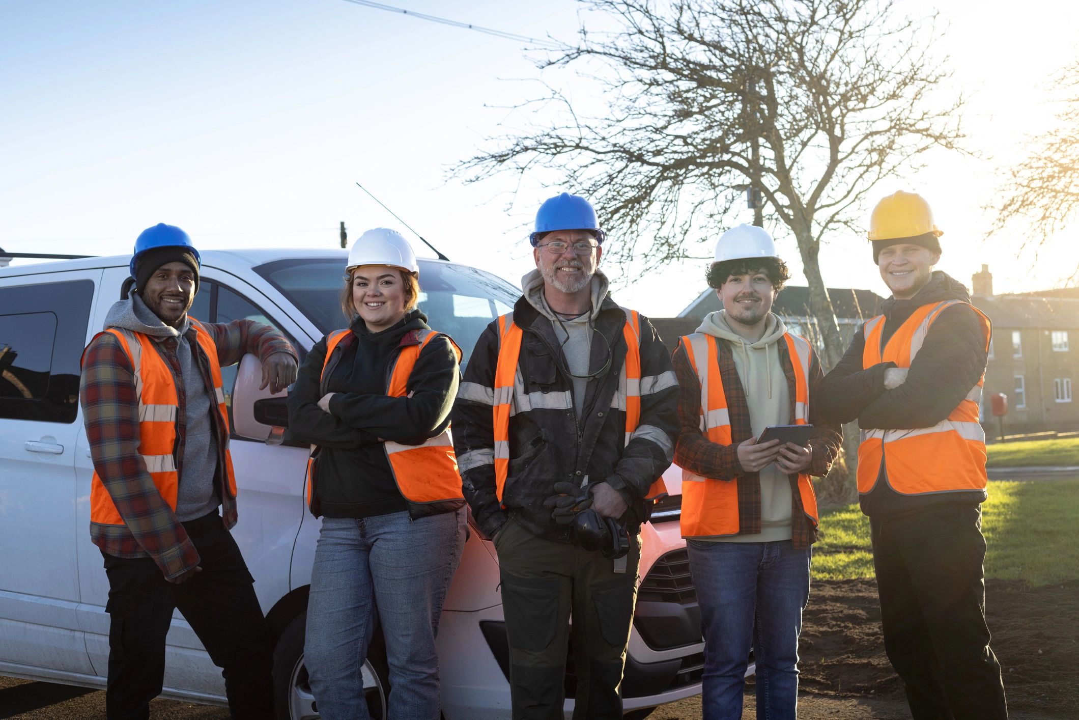 Team of skilled tradespeople standing together at a worksite